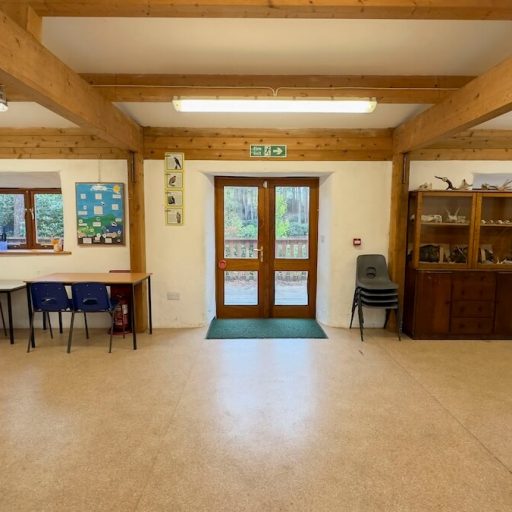 Indoor Classroom area with tables, chairs and whiteboard at avon tyrrell outdoor centre