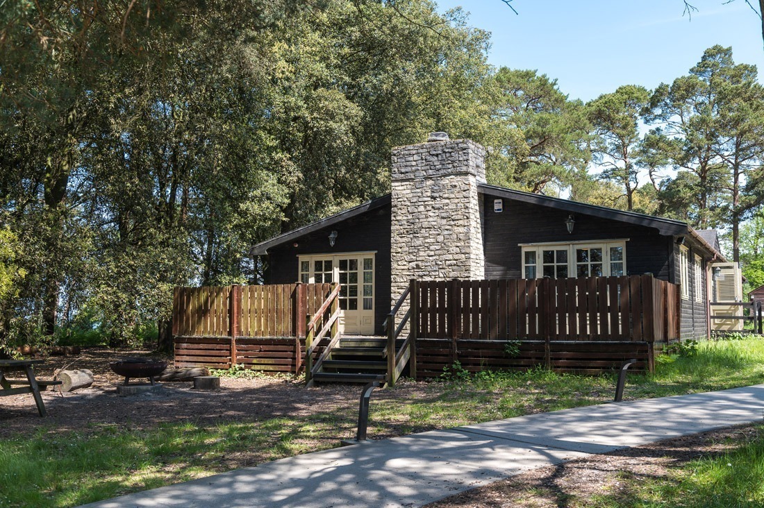 Lodge in the new forest at avon tyrrell with trees and nature - picnic bench and fire pit infront of lodge