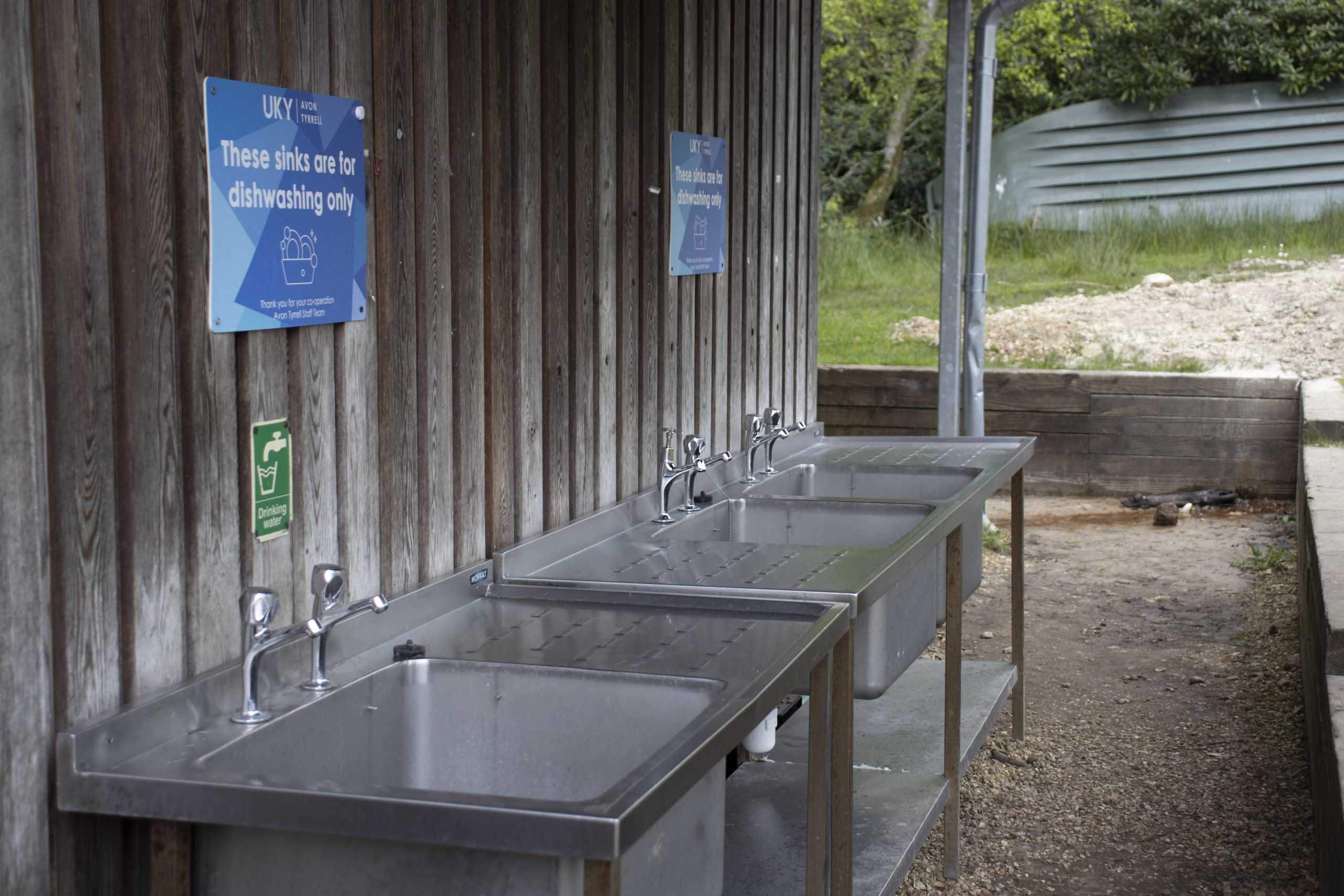 Avon Tyrrell wash up facilities at the boat house with three sinks in the forest