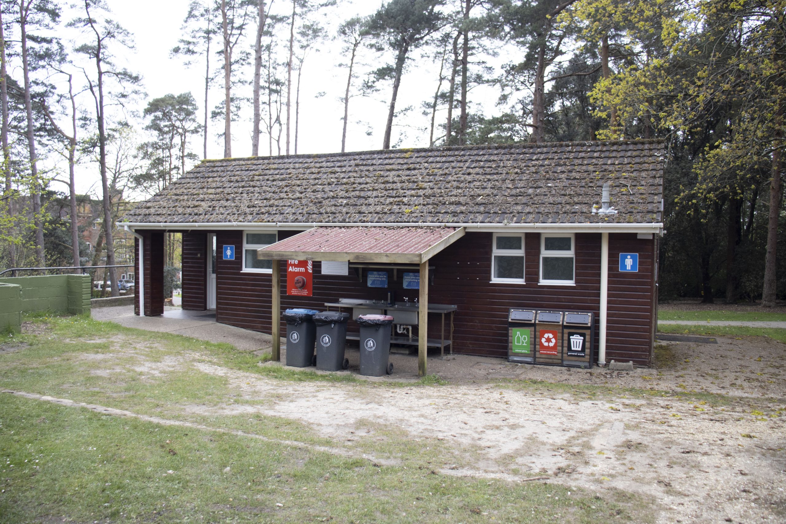 camping facilities block at Avon Tyrrell in the New Forest with bin storage and wash up faciltities