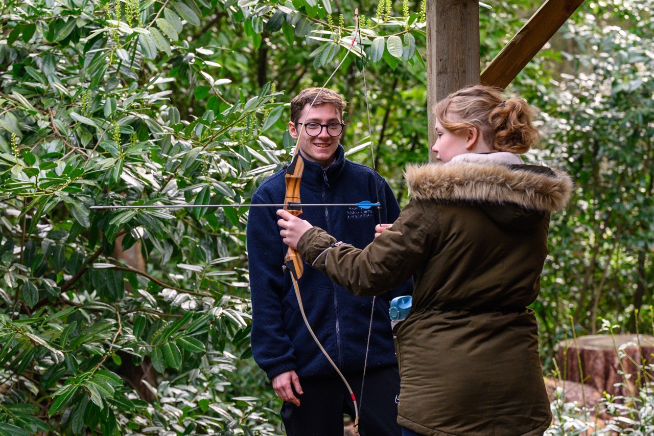 adventures away from home programme participants enjoying archery in the new forest with outdoor instructor